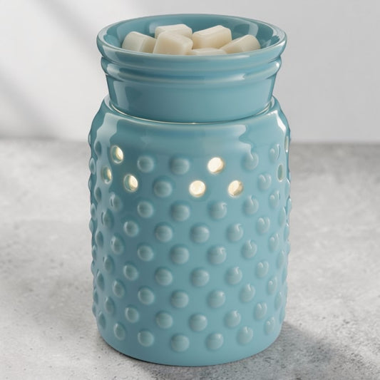 Blue Hobnail style candle wax warmer on a gray surface.