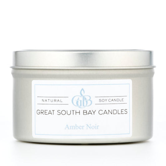Amber Noir 6oz candle in a silver travel tin.