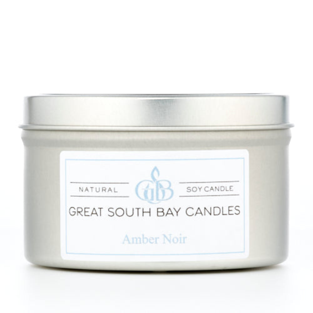 Amber Noir 6oz candle in a silver travel tin.