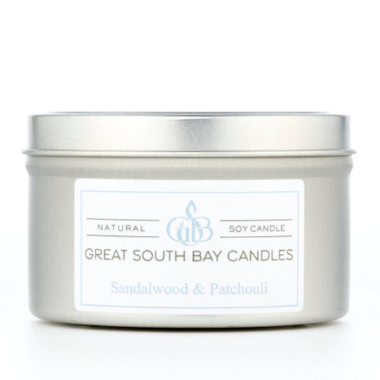 Sandalwood and Patchouli scented candle in a travel tin on a white background.