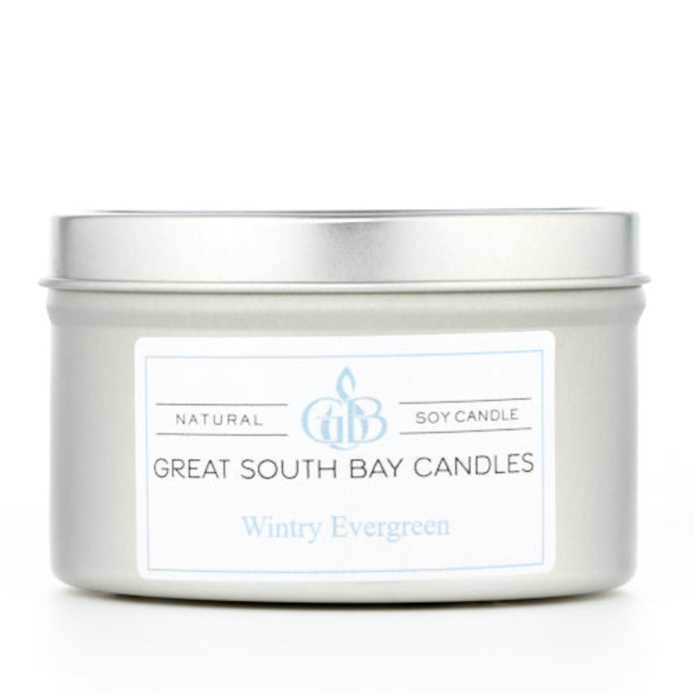 Wintry Evergreen scented candle in a silver tin on a white background.