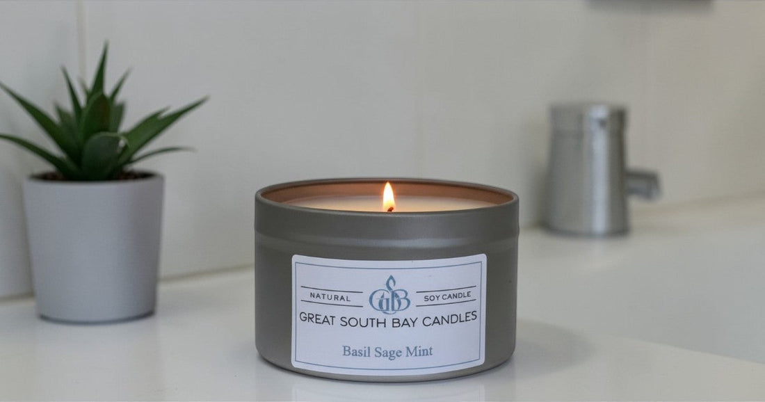 Basil Sage Mint candle on a bathroom counter top with a succulent plant in the background.