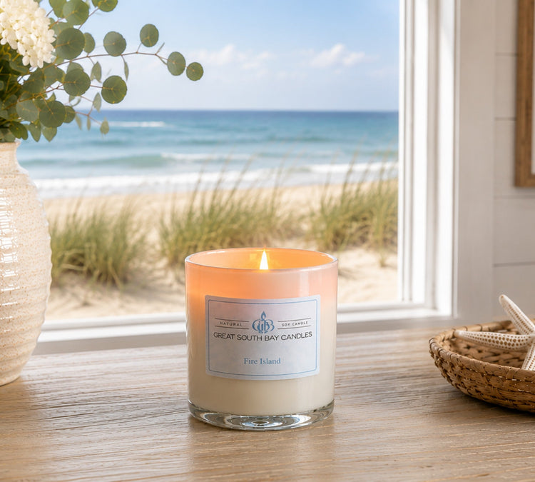 Fire Island beach scented candle on a console table in a coastal living room.