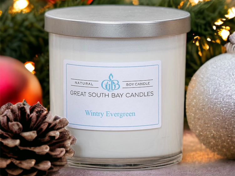 Wintry Evergreen scented soy candle in white glass tumbler with silver lid.