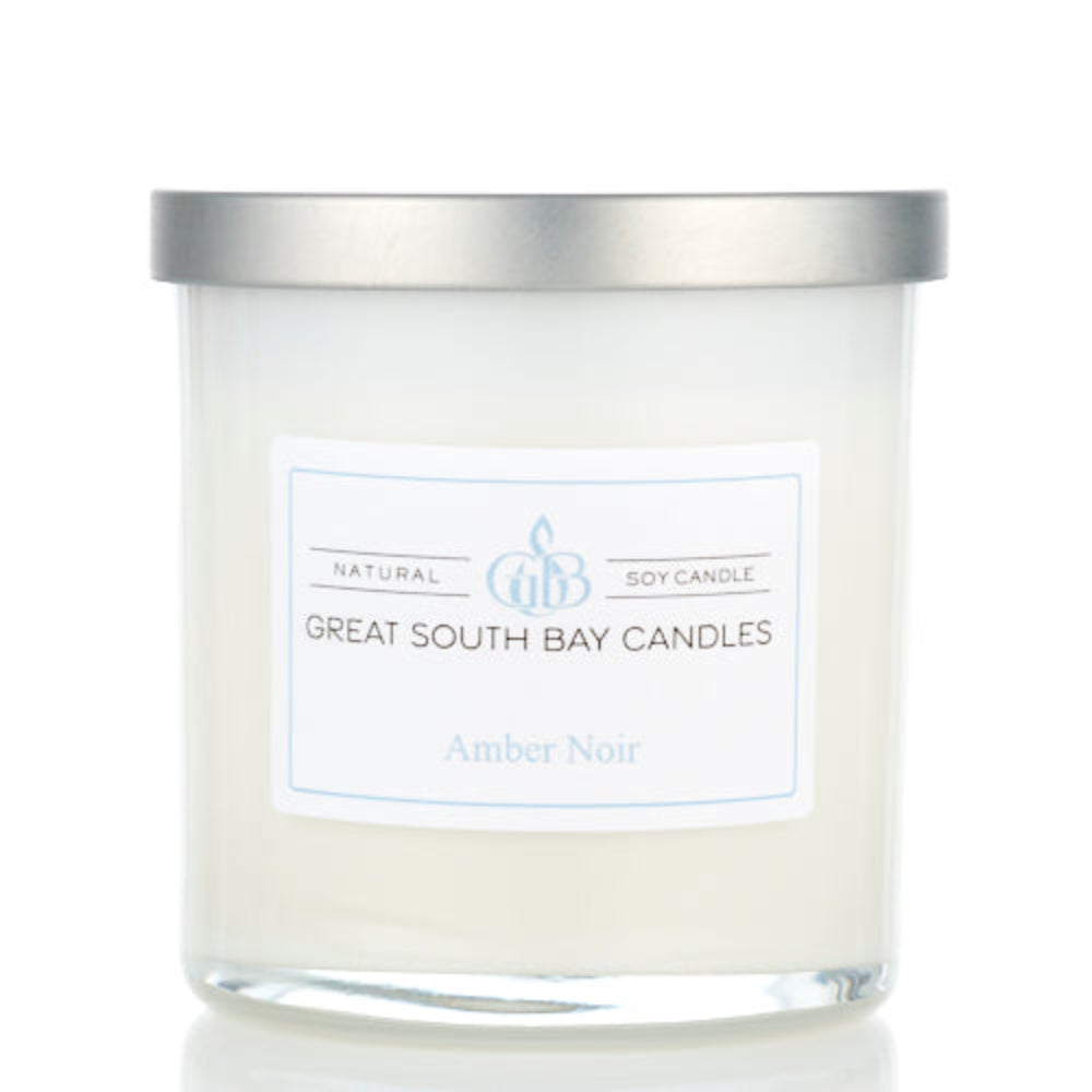 Amber Noir scented woody candle in a 8oz white glass tumbler with silver lid.