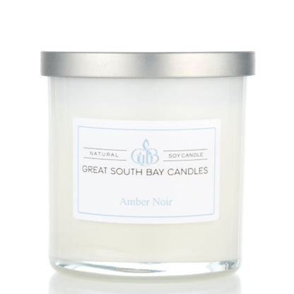 Amber Noir scented woody candle in a 8oz white glass tumbler with silver lid.