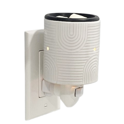 White plug in candle warmer on a white background.