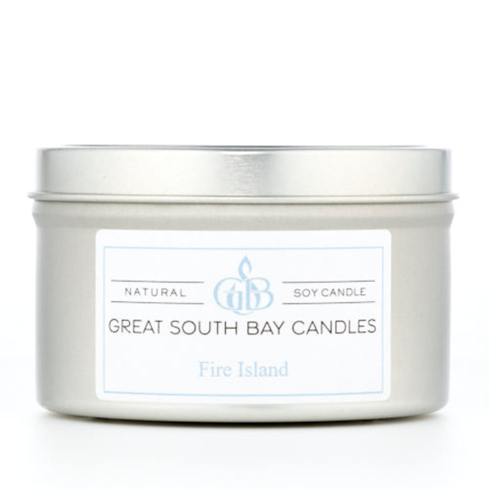 Fire Island beach scented candle in a travel tin on a white background.