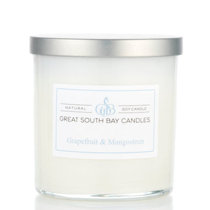 Great South Bay Candles grapefruit and mangosteen candle with silver lid on a white background
