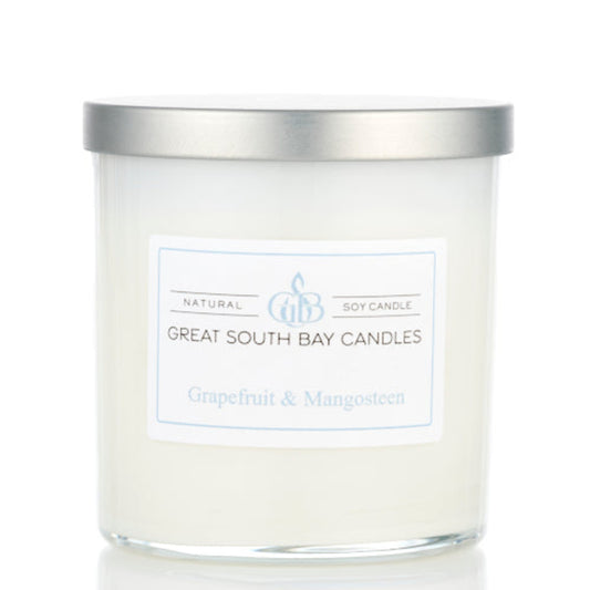 Great South Bay Candles grapefruit and mangosteen candle with silver lid on a white background