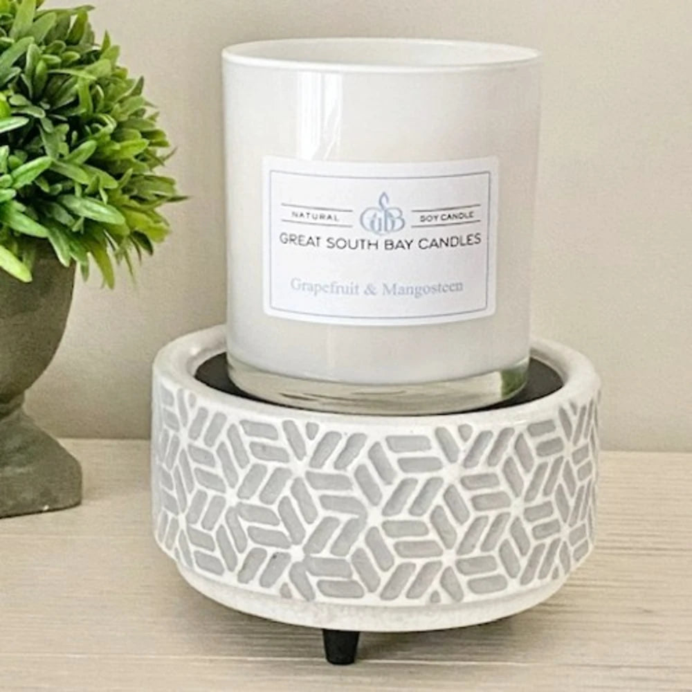 Jar candle on top of a grey candle warmer.