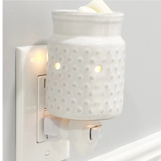 White Hobnail candle warmer plugged into an electric outlet.