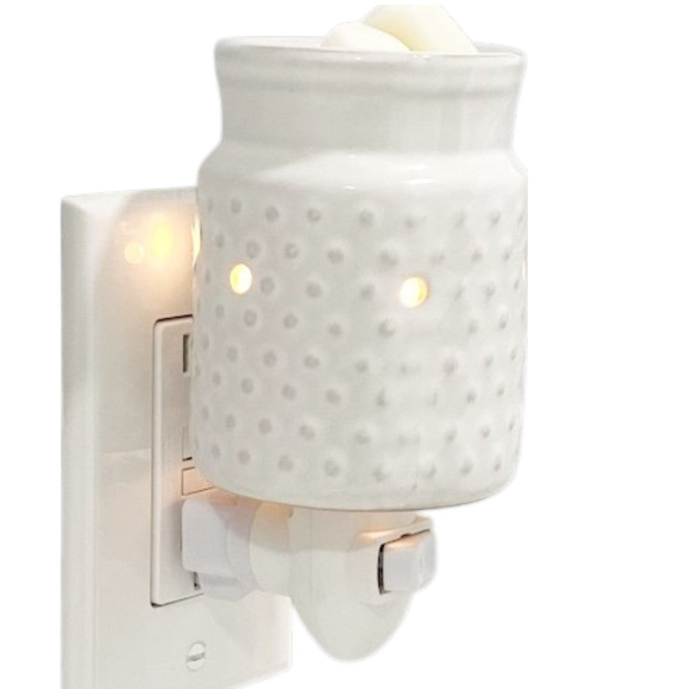 White hobnail candle wax warmer on a white background.