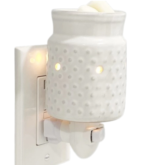 White hobnail candle wax warmer on a white background.
