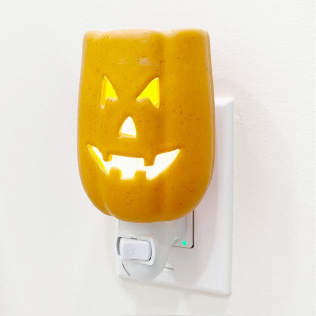 Orange jack o lantern pluggable candle wax warmer.