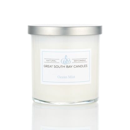 Ocean Mist tropical scented candle in a glass tumbler, with a silver lid on a white background.