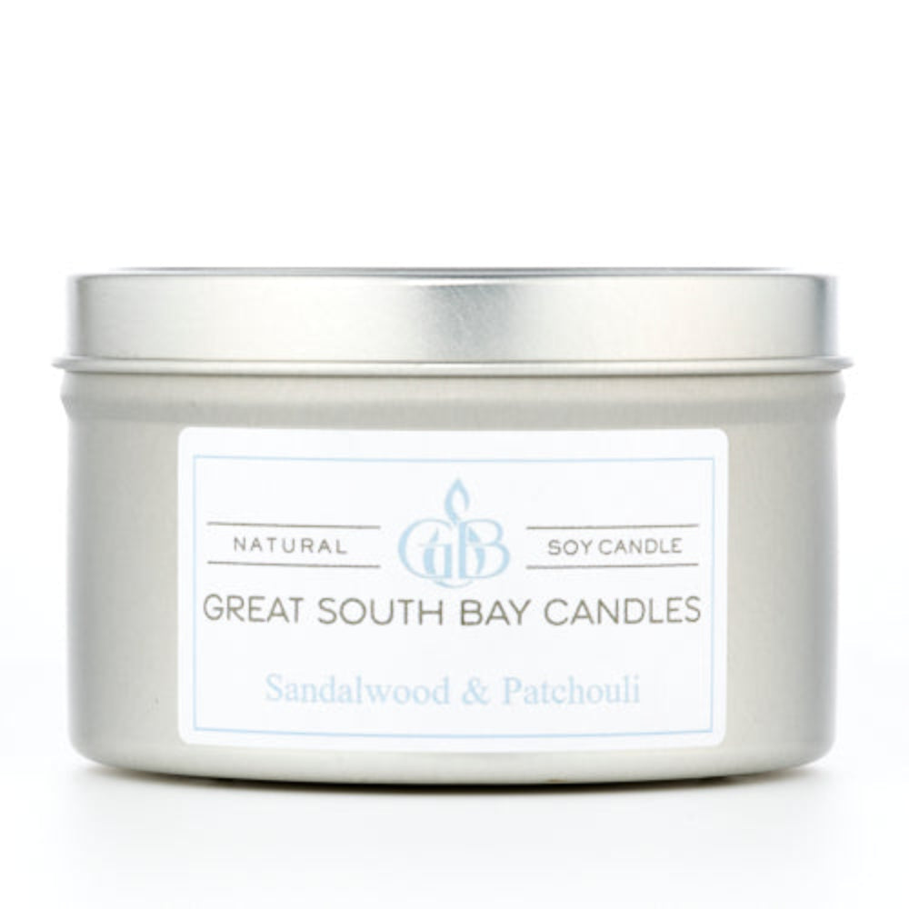 Sandalwood and Patchouli scented candle in a travel tin on a white background.
