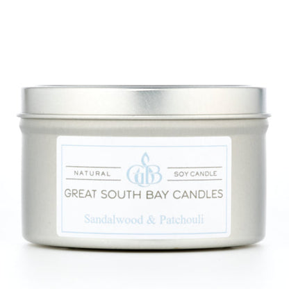 Sandalwood and Patchouli scented candle in a travel tin on a white background.