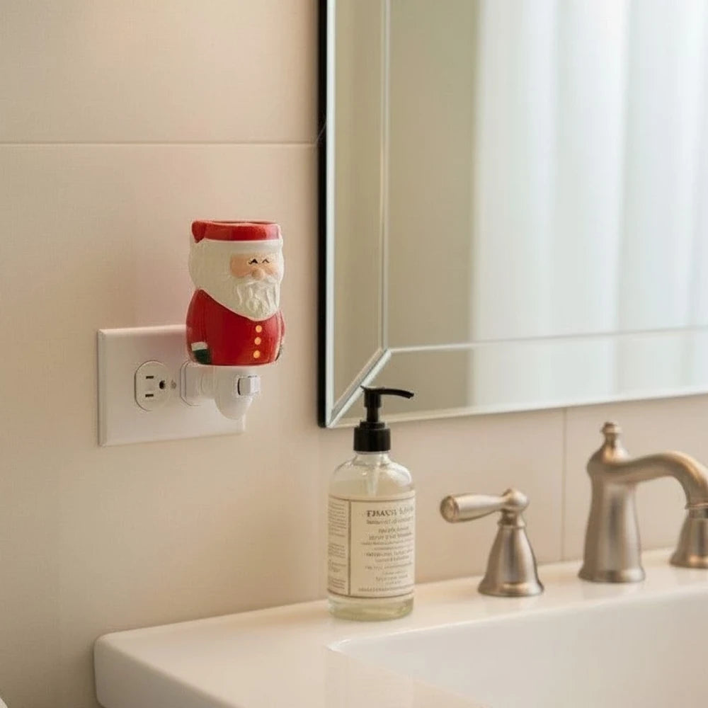 Santa Claus plug in wax warmer on a bathroom wall next to a sink with soap dispenser.