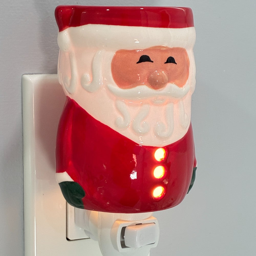Santa Claus wax warmer plugged into a wall outlet.