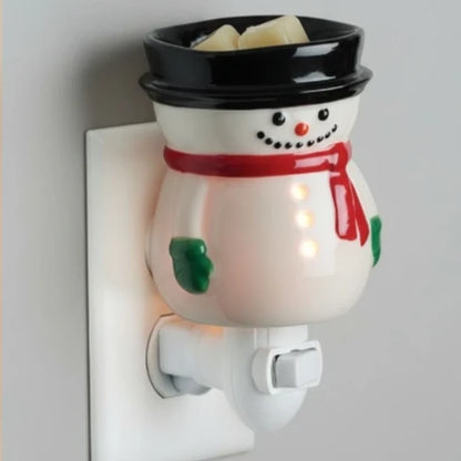 Snowman wall mounted candle warmer on a plain background.