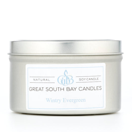 Wintry Evergreen scented candle in a silver tin on a white background.