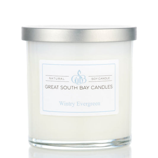 Evergreen candle in a 8oz white glass tumbler with a silver lid. 