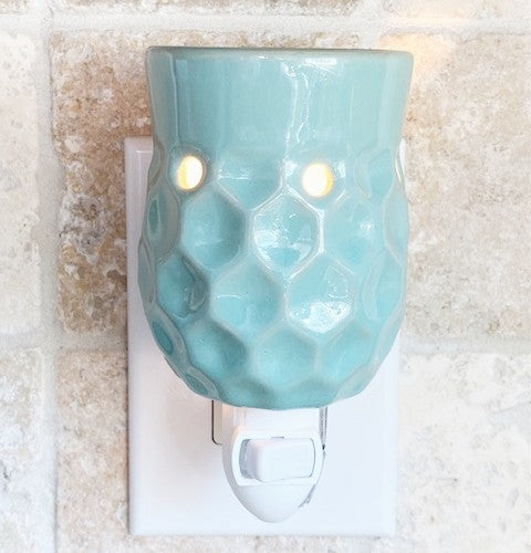 Honeycomb pluggable candle wax warmer in turquoise blue color. 