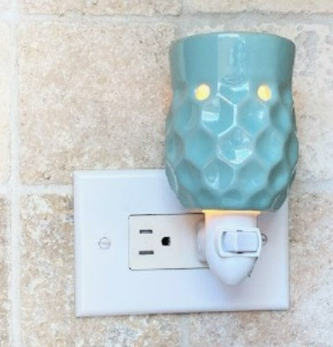 Honeycomb pluggable candle wax warmer pictured with vertical outlet.